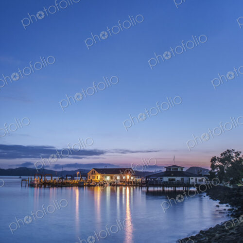 Illuminated buildings on water at dawn Illuminated buildings on water at dawn