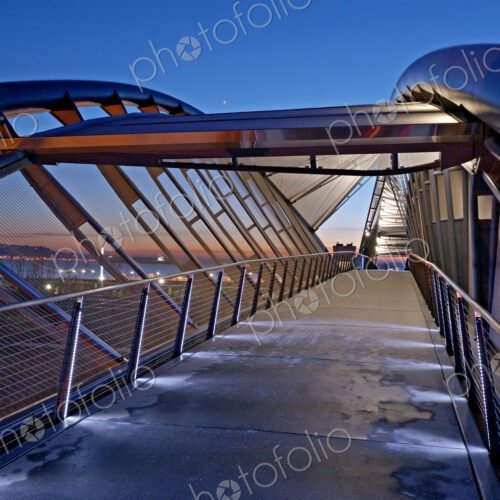 Illuminated footbridge over Seattle cityscape at night, Washington, United States