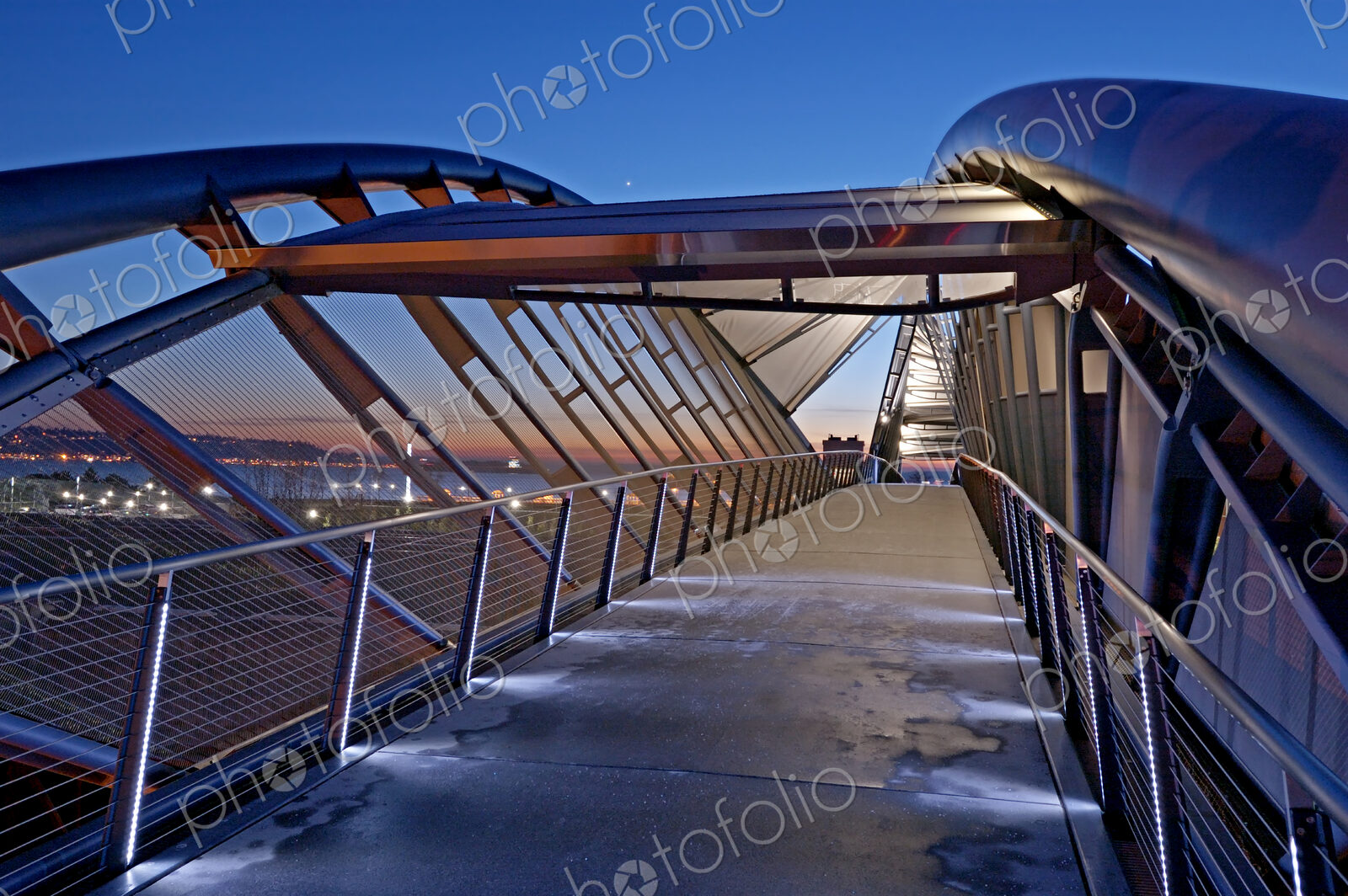 Illuminated footbridge over Seattle cityscape at night, Washington, United States