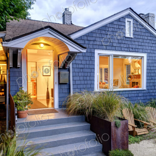 Illuminated front stoop and of blue house Illuminated front stoop and of blue house
