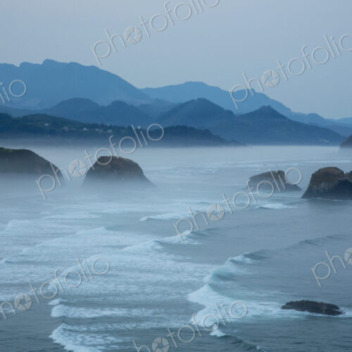 Indian Beach on Ecola State Parl with mist over waves breaking at dawn.