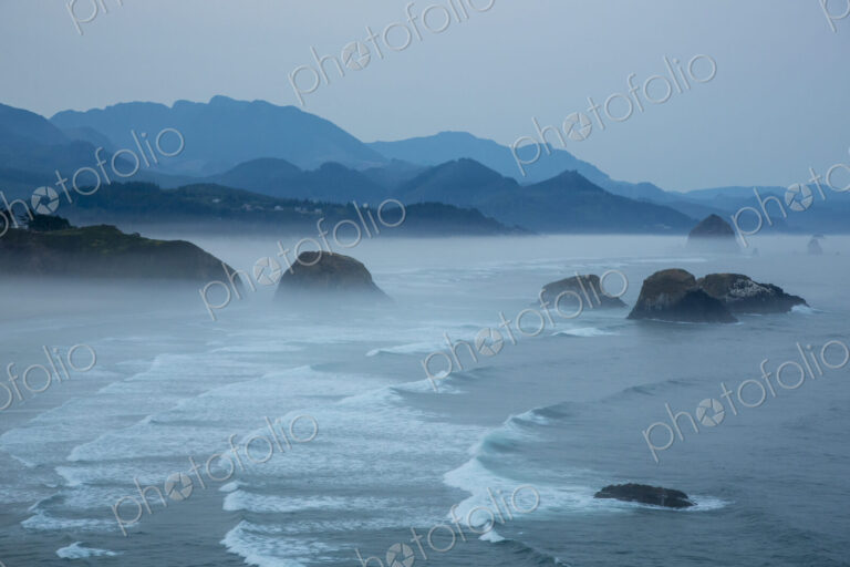 Indian Beach on Ecola State Parl with mist over waves breaking at dawn.