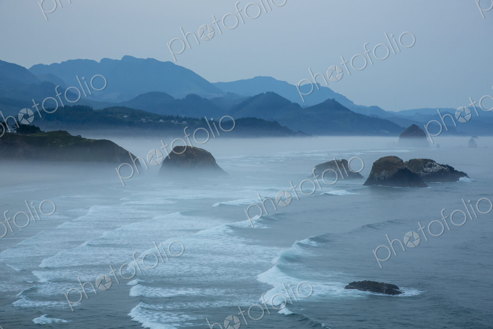 Indian Beach on Ecola State Parl with mist over waves breaking at dawn.