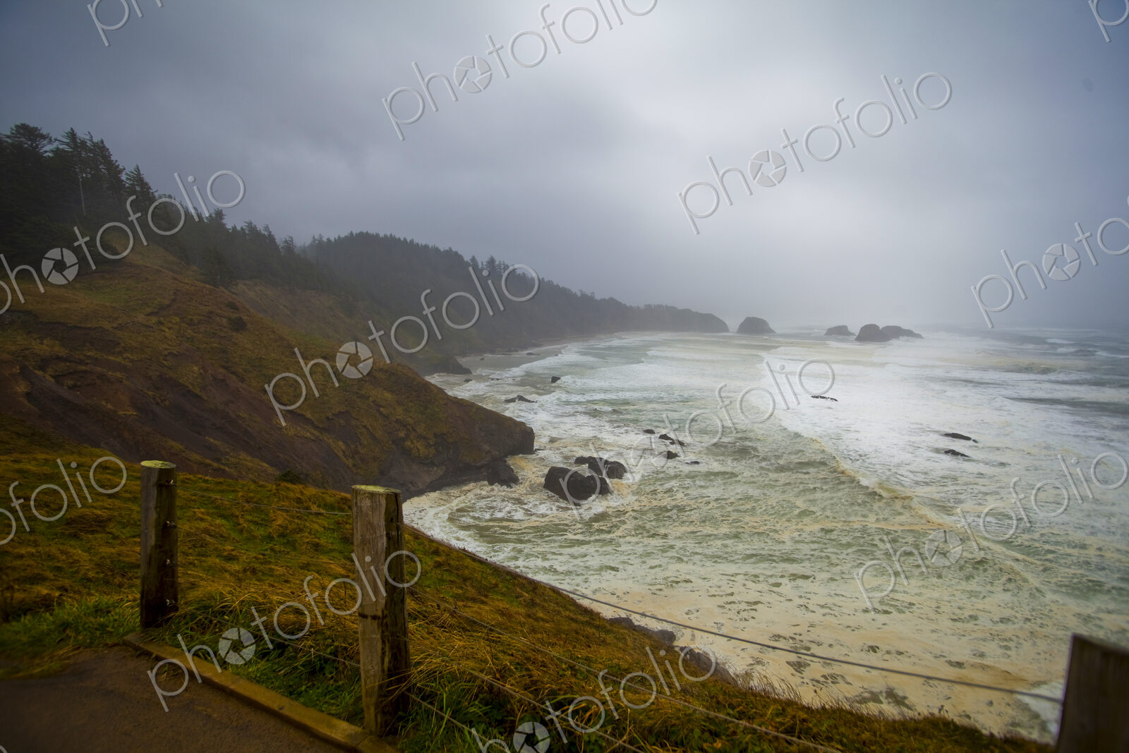 Indian Cove, Oregon Coast, the curving coastline and stormy seas breaking on shore.