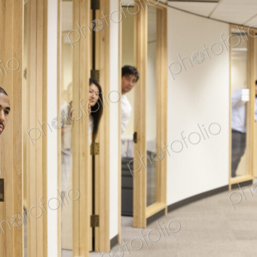 Individual business people looking out the doorway of their offices. Individual business people looking out the doorway of their offices.