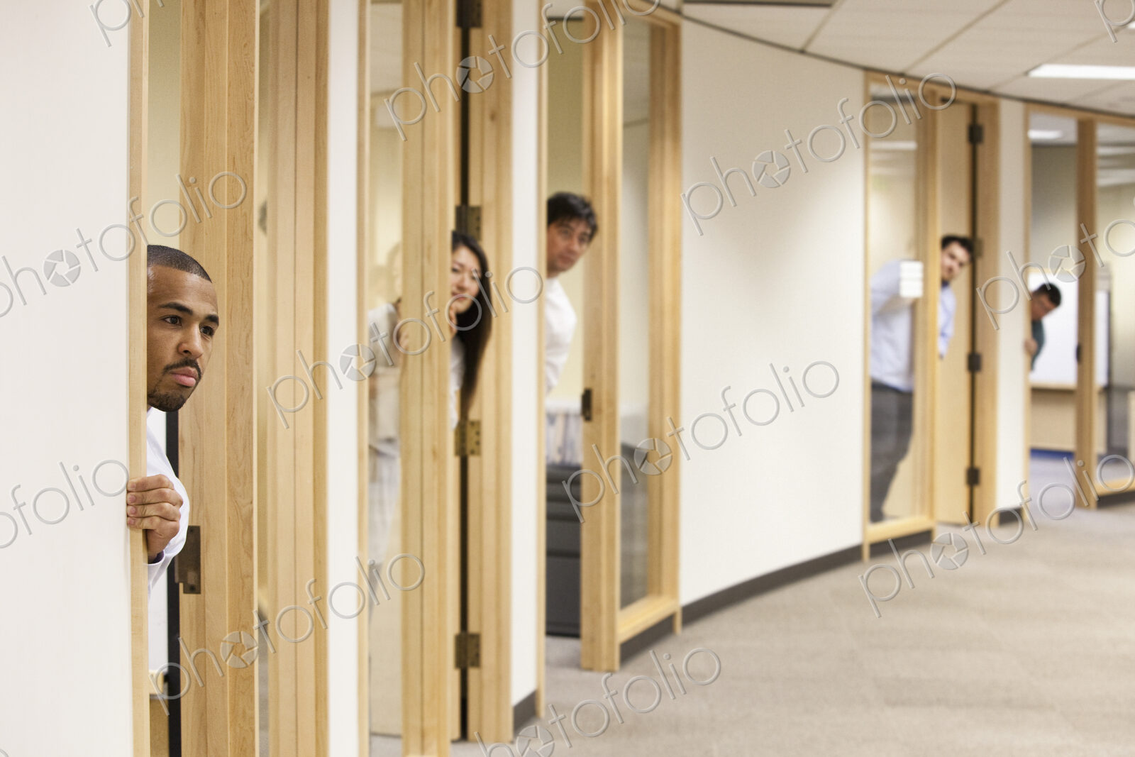 Individual business people looking out the doorway of their offices.