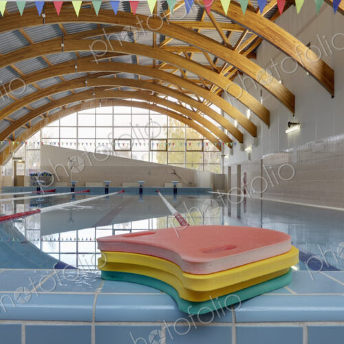 Indoor swimming pool, starting block, diving block and marked lanes, flat calm water Indoor swimming pool, starting block, diving block and marked lanes, flat calm water