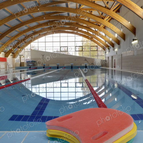 Indoor swimming pool, starting block, diving block and marked lanes, flat calm water Indoor swimming pool, starting block, diving block and marked lanes, flat calm water