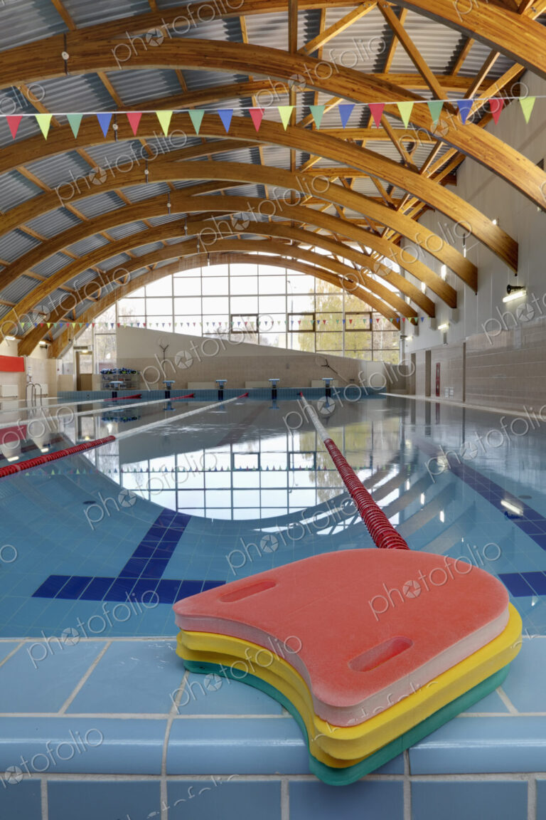 Indoor swimming pool, starting block, diving block and marked lanes, flat calm water