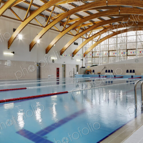 Indoor swimming pool with marked lanes, flat calm water Indoor swimming pool with marked lanes, flat calm water