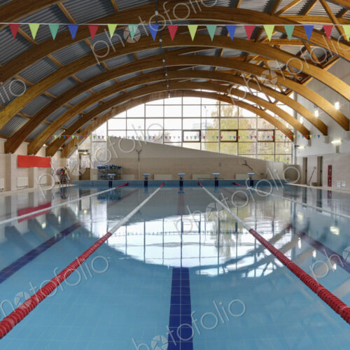 Indoor swimming pool with marked lanes, flat calm water Indoor swimming pool with marked lanes, flat calm water