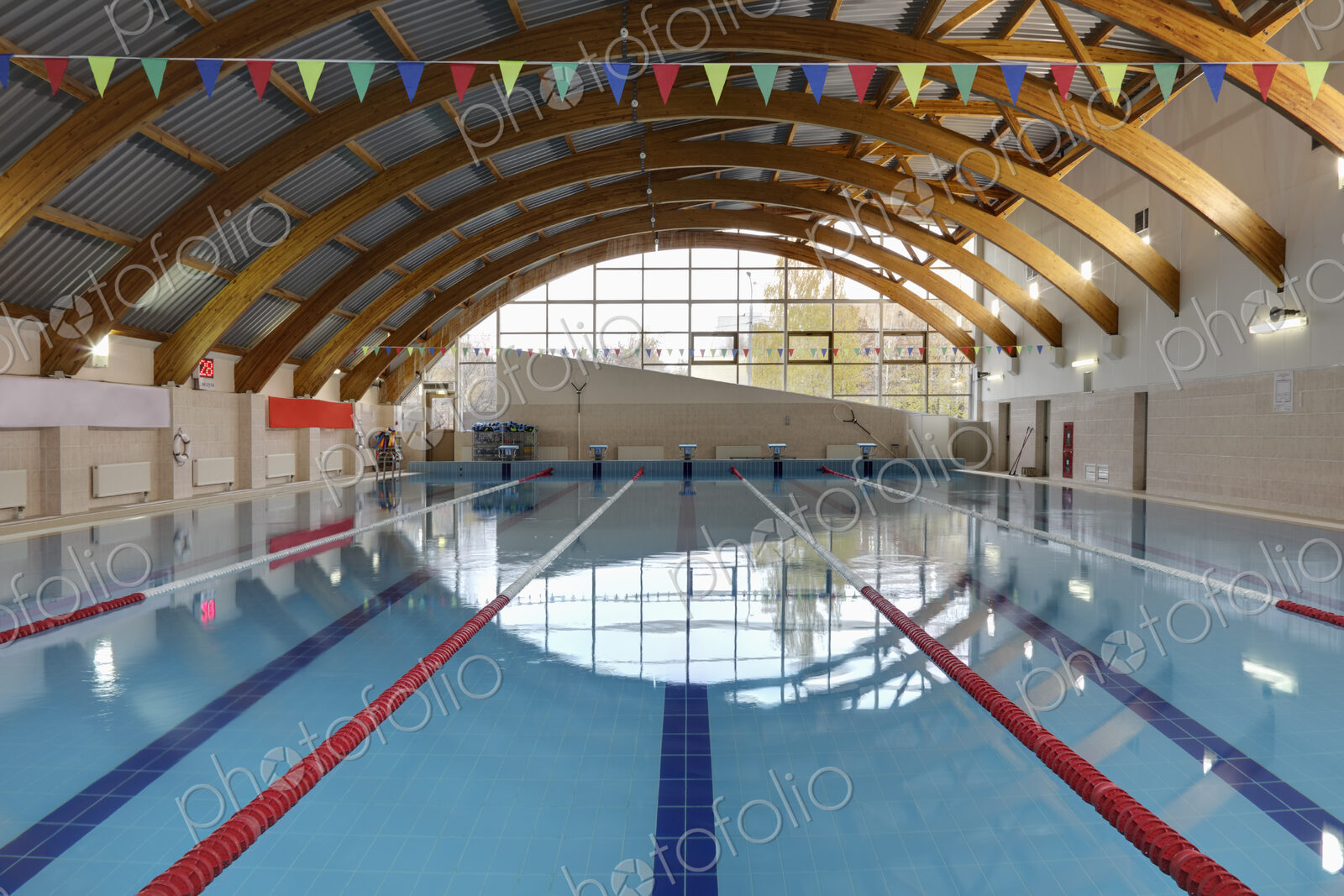 Indoor swimming pool with marked lanes, flat calm water