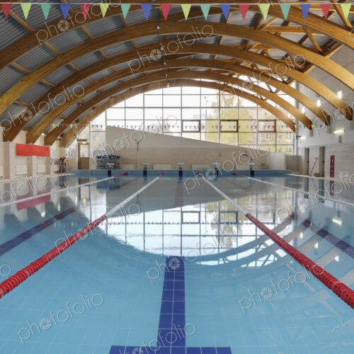 Indoor swimming pool with marked lanes, flat calm water Indoor swimming pool with marked lanes, flat calm water