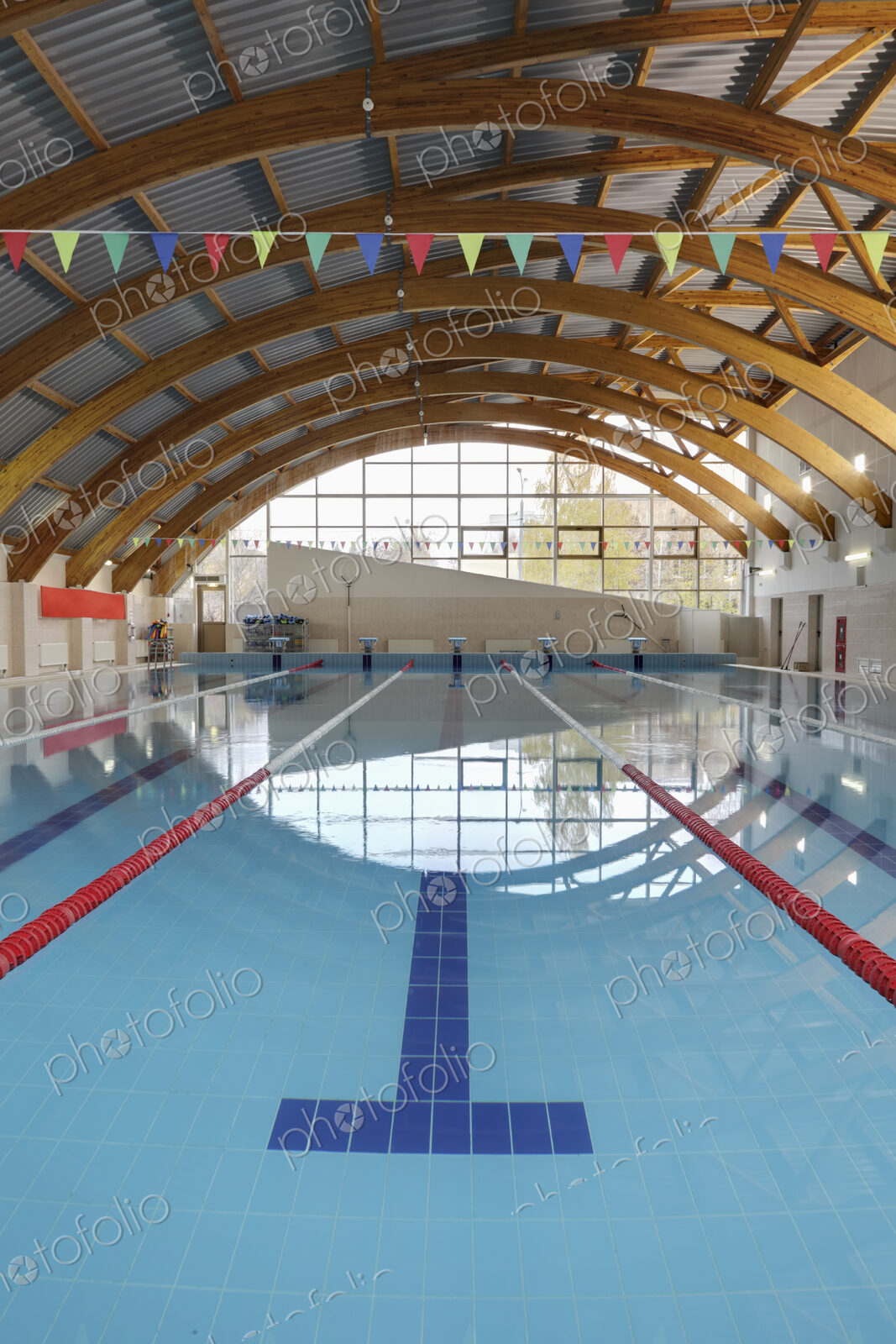 Indoor swimming pool with marked lanes, flat calm water