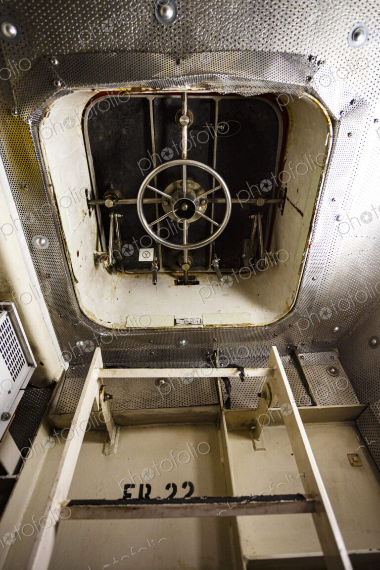 Interior door of a ferry, a ladder and a watertight door with a wheel locking mechanism.