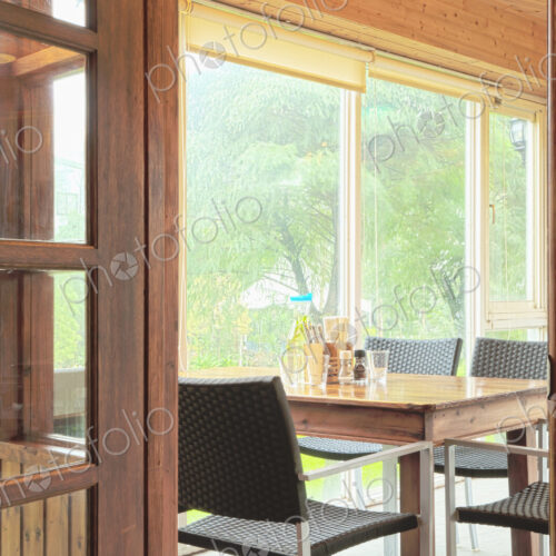 Interior of a dining room with windows onto woodland. Interior of a dining room with windows onto woodland.