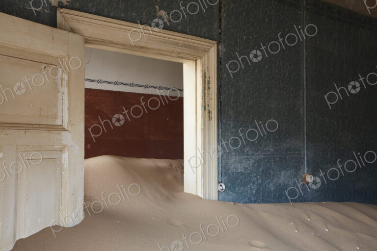 Interior of an abandoned building full of sand.
