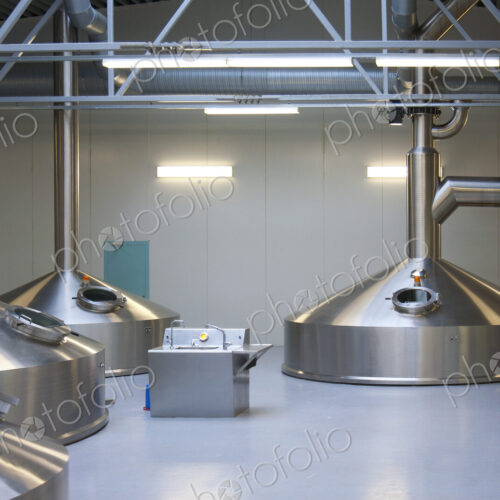 Interior of brewery, large steel storage tanks for brewing beer.