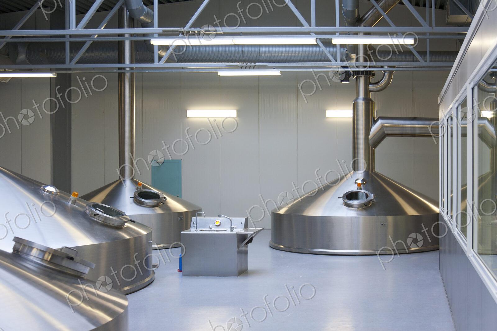 Interior of brewery, large steel storage tanks for brewing beer.