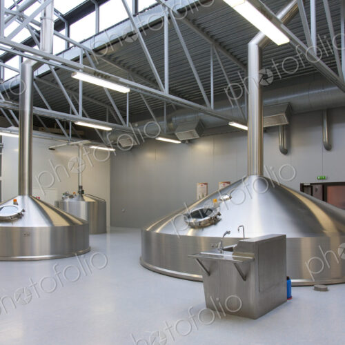 Interior of brewery, large steel storage tanks for brewing beer.
