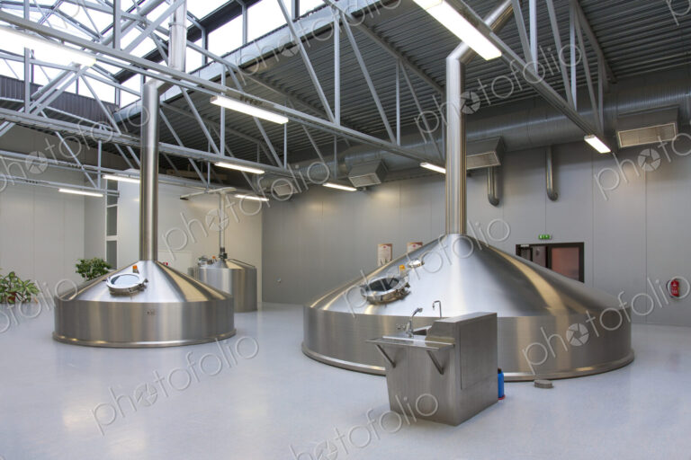 Interior of brewery, large steel storage tanks for brewing beer.