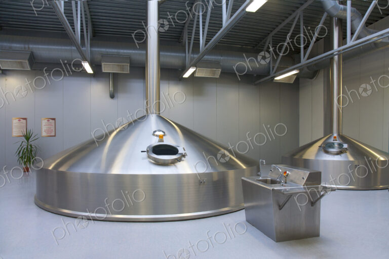 Interior of brewery, large steel storage tanks for brewing beer.