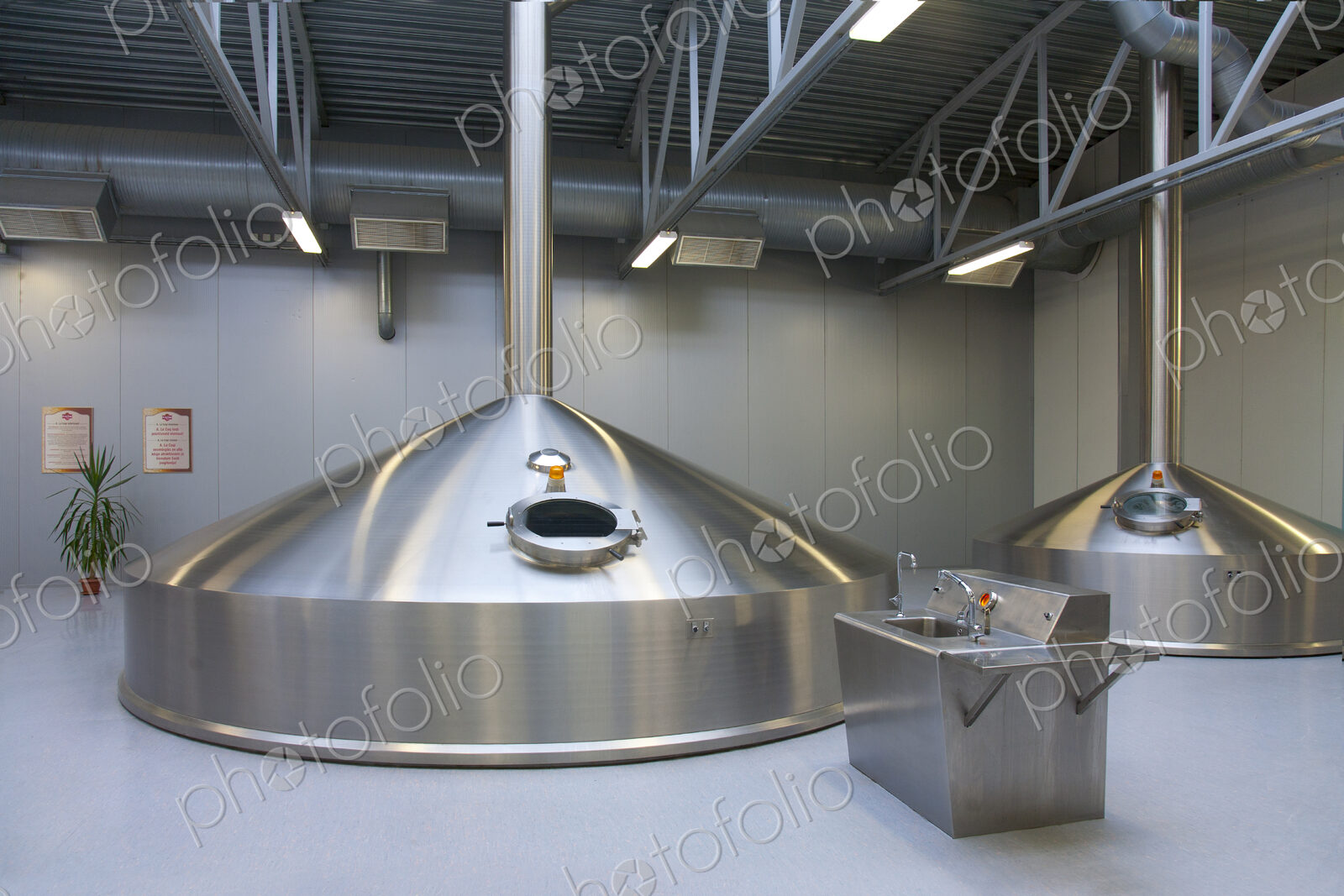 Interior of brewery, large steel storage tanks for brewing beer.