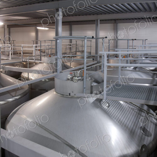 Interior of brewery, large steel storage tanks for brewing beer.