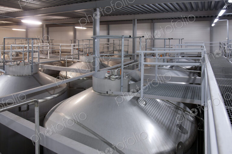 Interior of brewery, large steel storage tanks for brewing beer.