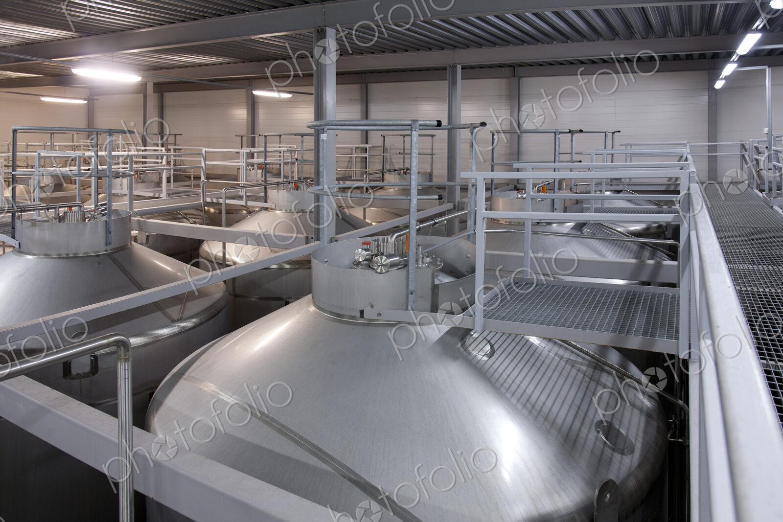 Interior of brewery, large steel storage tanks for brewing beer.