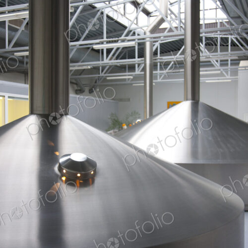 Interior of brewery, large steel storage tanks for brewing beer.