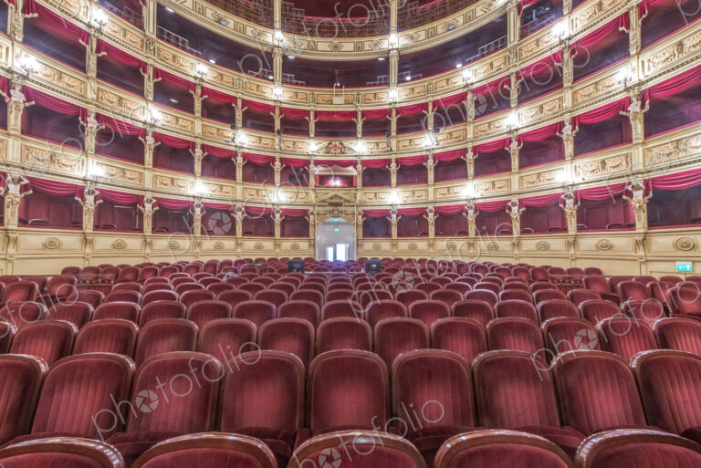 Interior of the Teatro Verdi, red velvet seats in the auditorium, Trieste, Italy.
