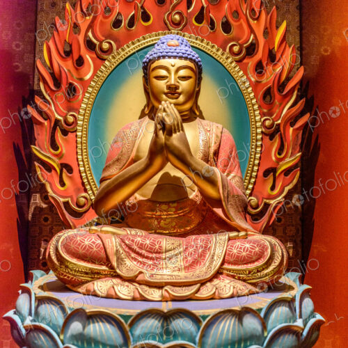 Interior view of a Buddhist Temple in Singapore, a seated buddha on a lotus flower. Interior view of a Buddhist Temple in Singapore, a seated buddha on a lotus flower.