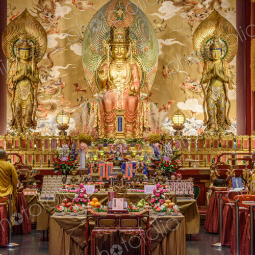 Interior view of a Buddhist Temple in Singapore, an altar with images of the buddha,… Interior view of a Buddhist Temple in Singapore, an altar with images of the buddha,…
