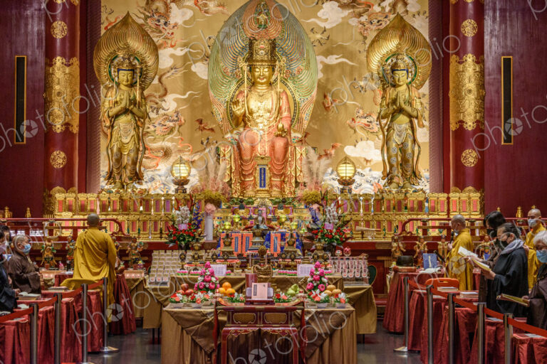 Interior view of a Buddhist Temple in Singapore, an altar with images of the buddha,…