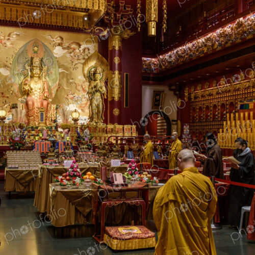 Interior view of a Buddhist Temple in Singapore, worshippers and statues of the buddha. Interior view of a Buddhist Temple in Singapore, worshippers and statues of the buddha.