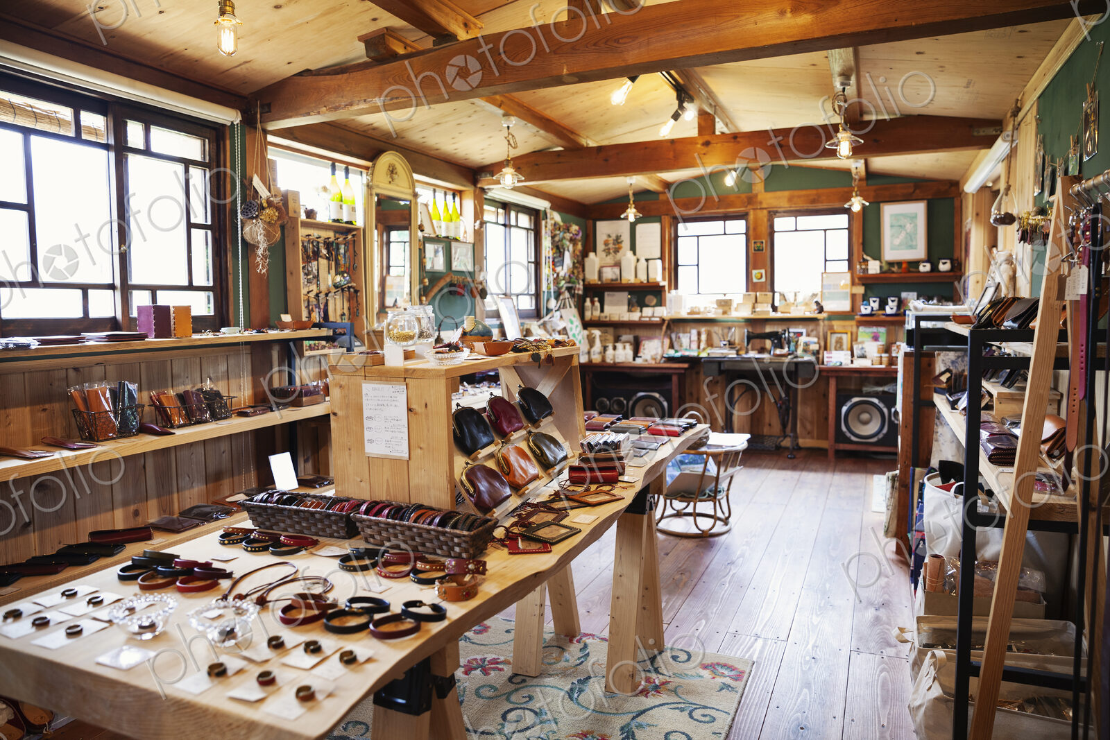 Interior view of a leather shop selling belts, bracelets and handbags.