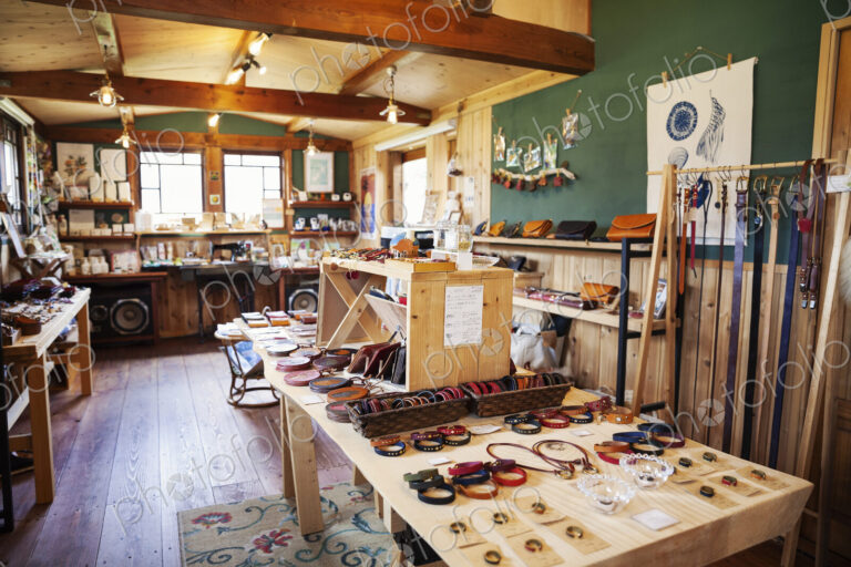 Interior view of a leather shop selling belts, bracelets and handbags.