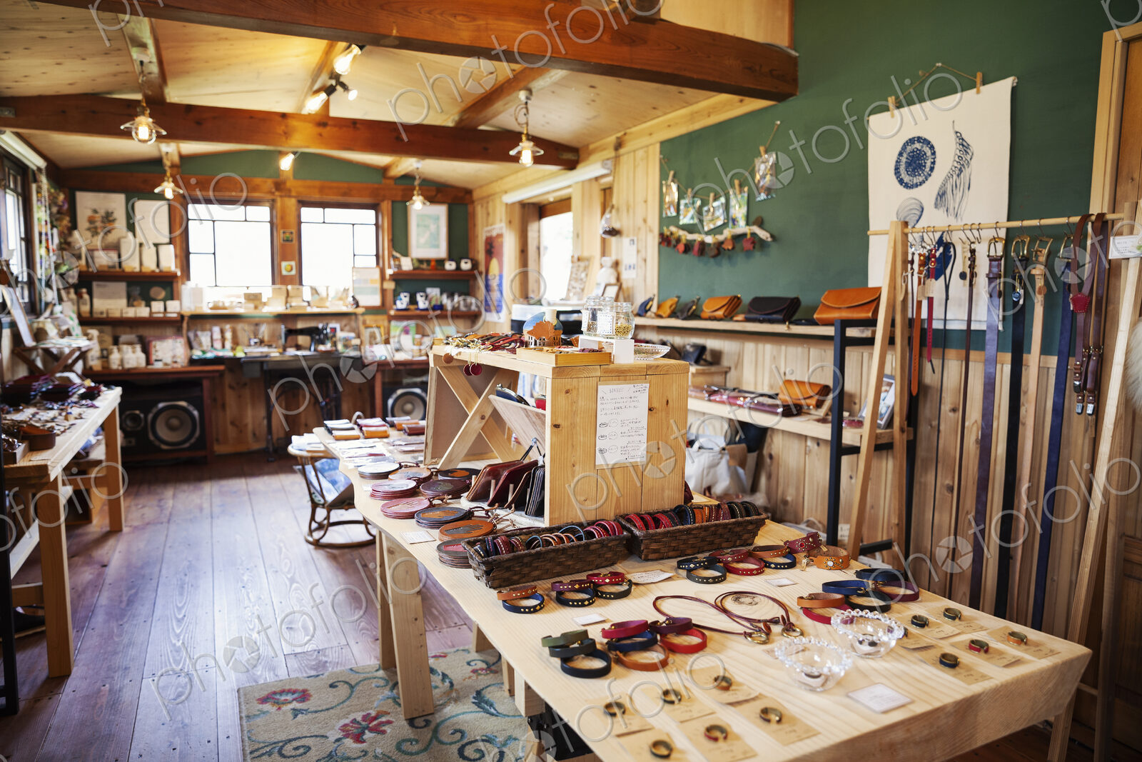 Interior view of a leather shop selling belts, bracelets and handbags.