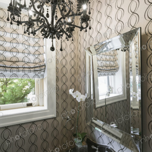 Interior view of a luxurious bathroom with pattern wallpaper and chandelier, Virginia,…