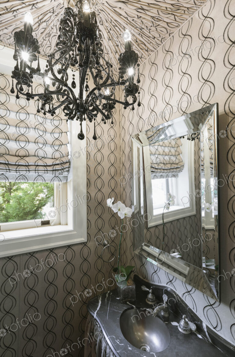 Interior view of a luxurious bathroom with pattern wallpaper and chandelier, Virginia,…