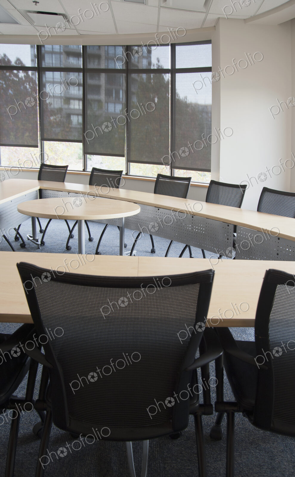 Interior view of a meeting room with a long narrow table set out with a space in the…