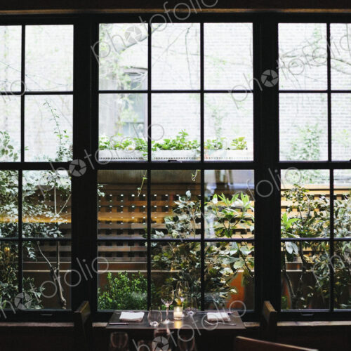 Interior view of a restaurant in Manhattan's West Village, window overlooking a garden. Interior view of a restaurant in Manhattan's West Village, window overlooking a garden.