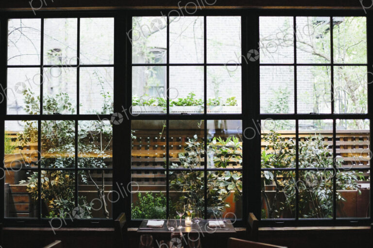 Interior view of a restaurant in Manhattan's West Village, window overlooking a garden.