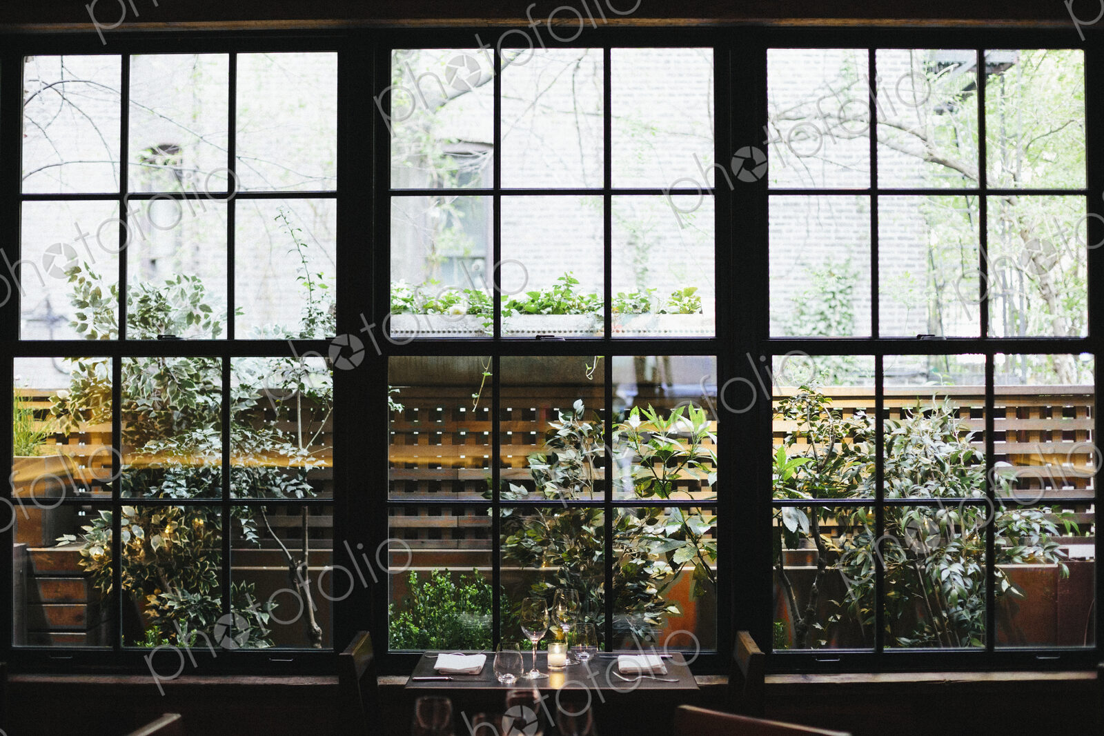 Interior view of a restaurant in Manhattan’s West Village, window overlooking a garden.