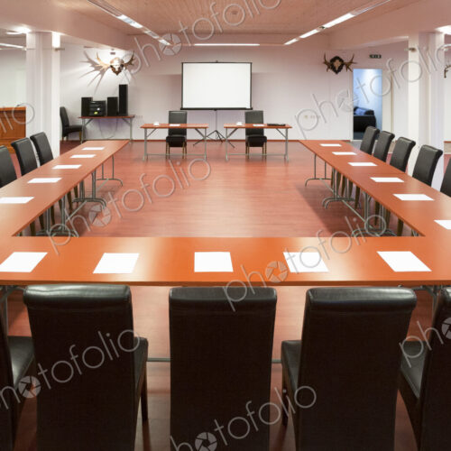 Interior view of a spacious conference room, a large table and chairs and a… Interior view of a spacious conference room, a large table and chairs and a…