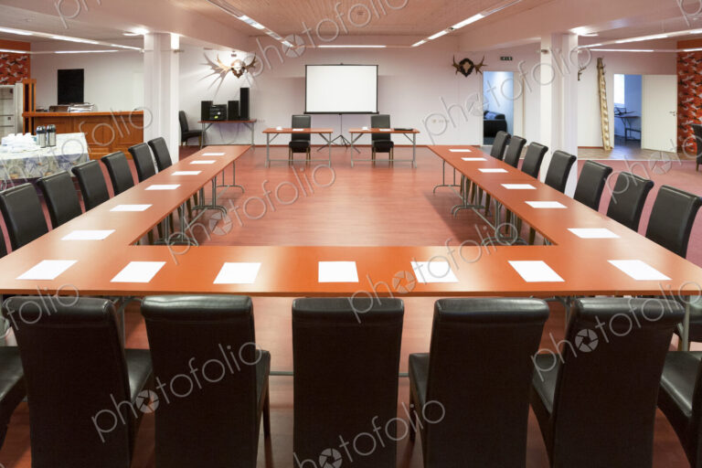 Interior view of a spacious conference room, a large table and chairs and a…