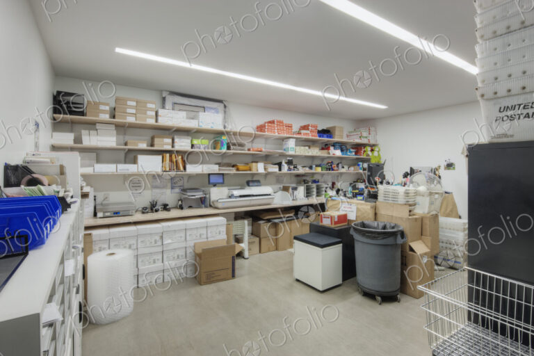 Interior view of a storeroom in an office building with stacks of paper and cardboard…