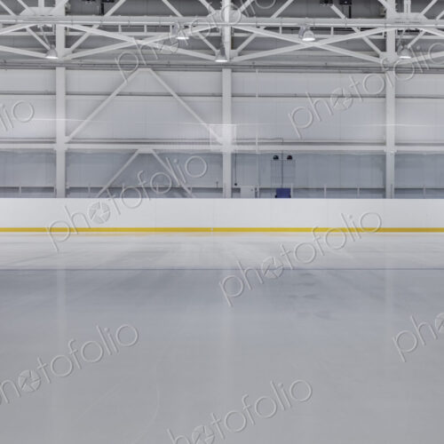 Interior view of an ice rink with ice hockey markings.