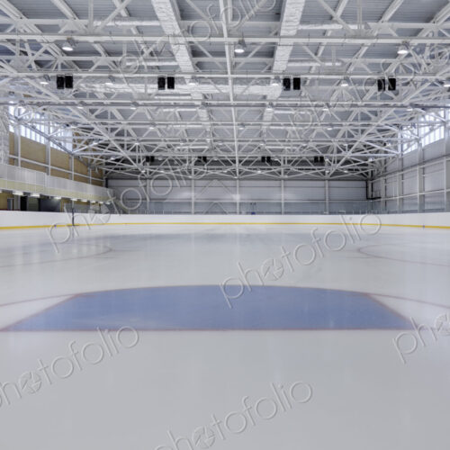 Interior view of an ice rink with ice hockey markings.